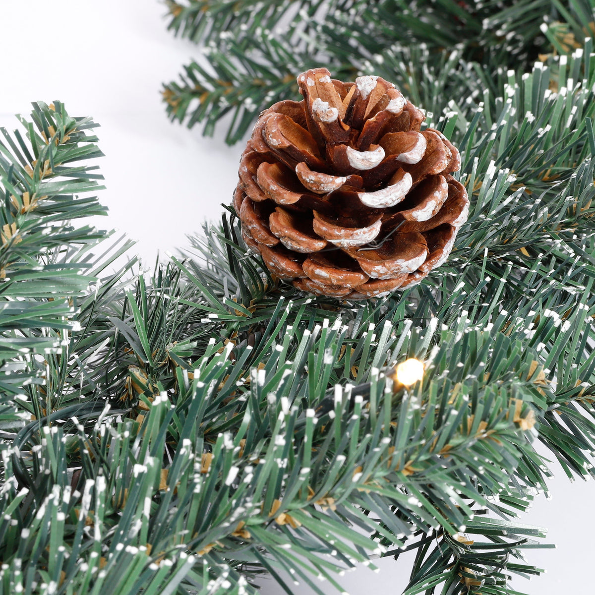 Snow-dusted pine cone on Creston fir garland with lights, 10 m long