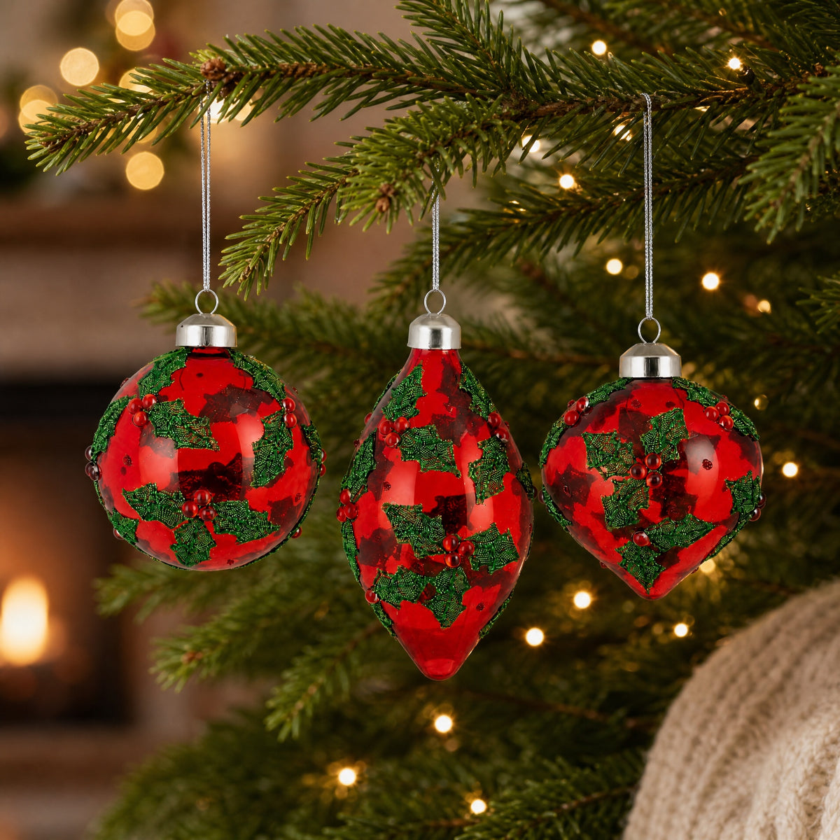 Red glass Christmas baubles with holly
