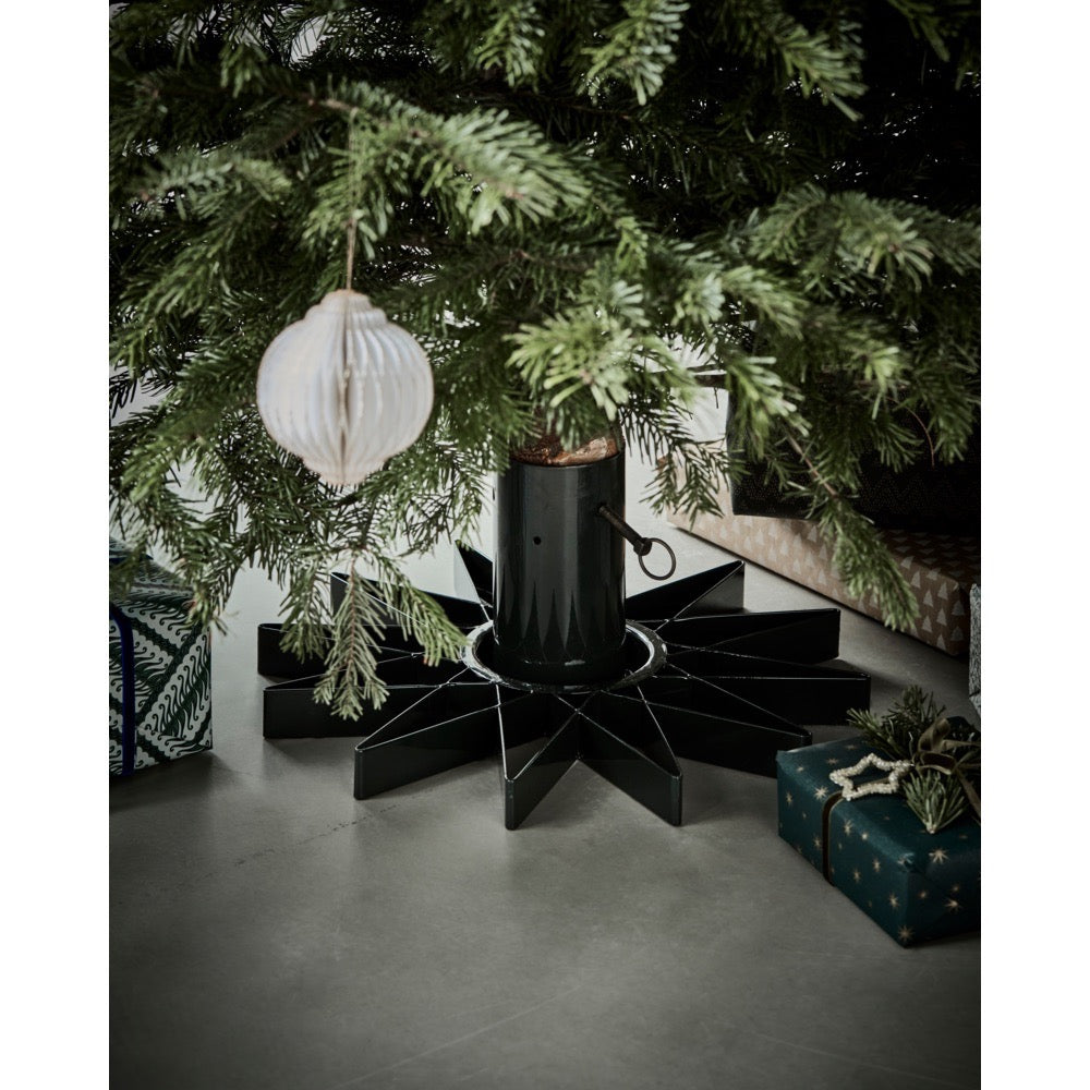 Christmas tree in a star-shaped stand from House Doctor with presents under the tree