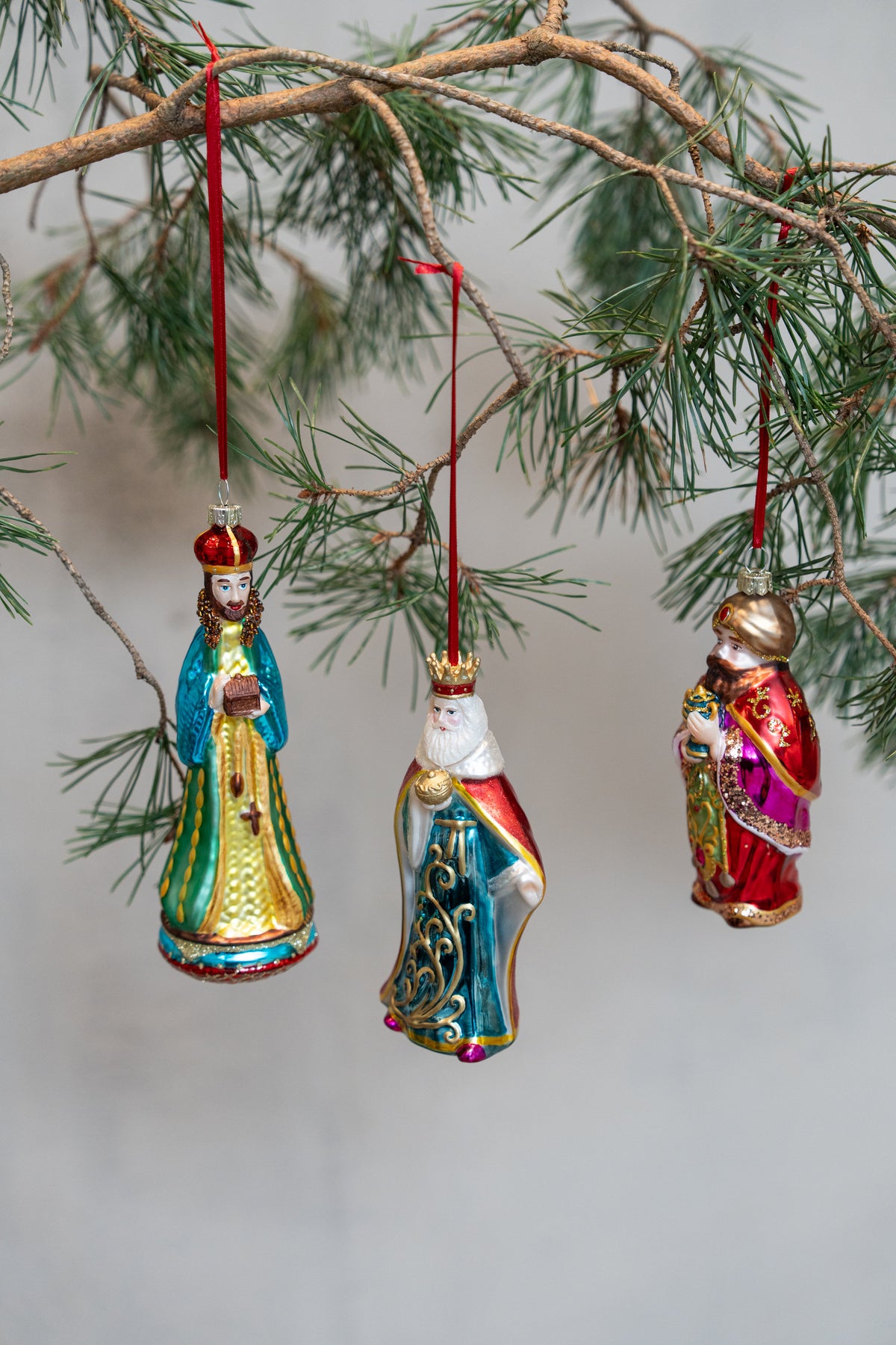 Three Wise Men glass figurine baubles from Speedtsberg hanging on a pine branch