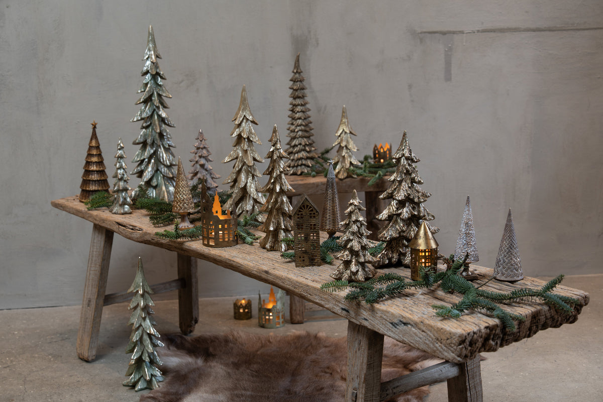 Christmas display with spruce trees and illuminated houses from Speedtsberg on a wooden bench