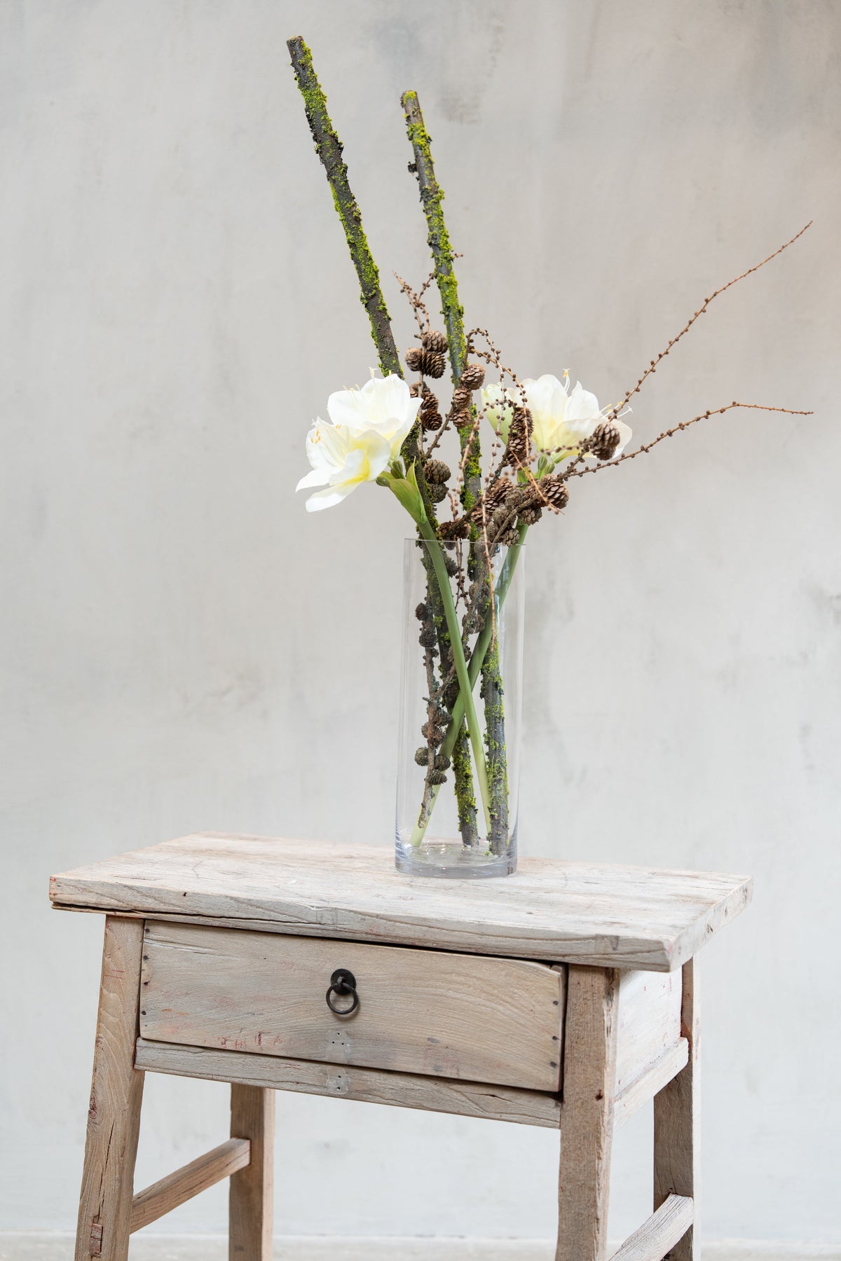 Vase with pine cone branches, moss-covered branches and artificial white amaryllis flowers from Speedtsberg