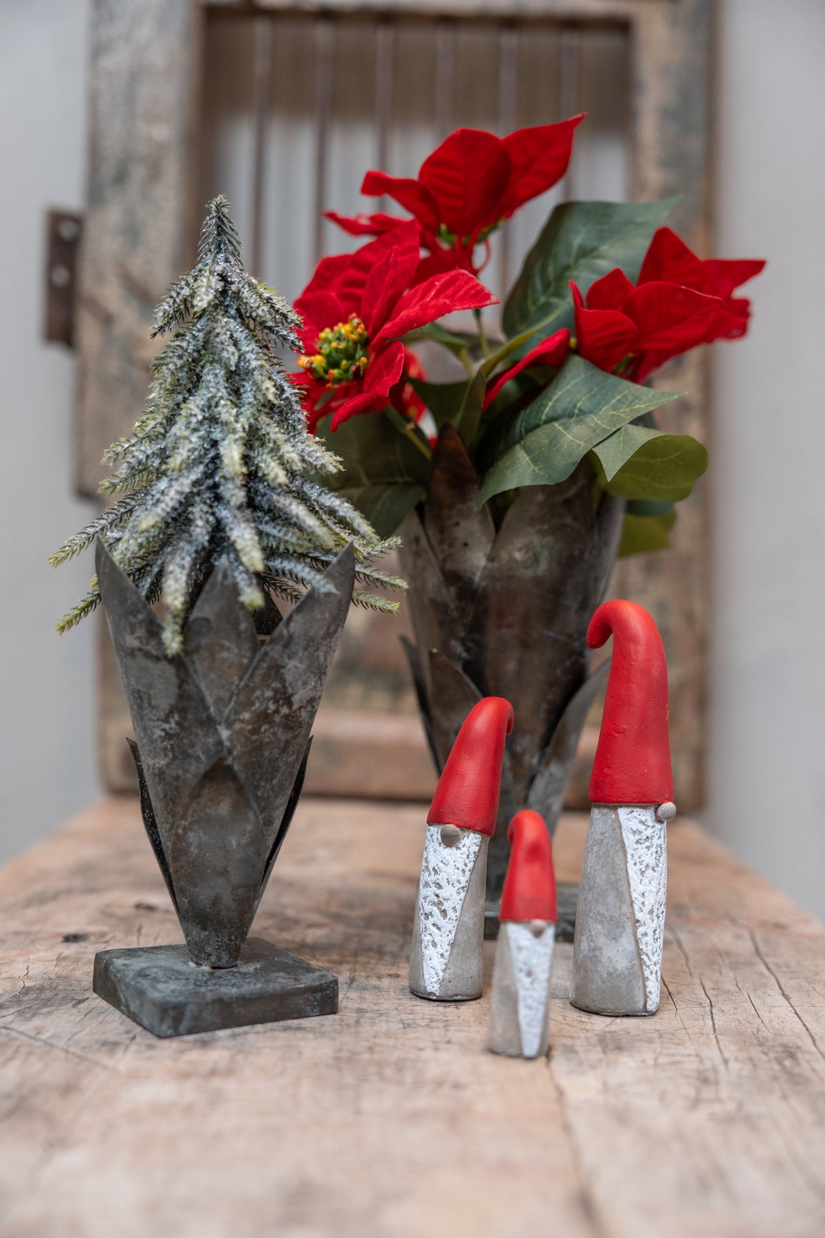 Rustic vases with artificial poinsettia bouquet and fir tree