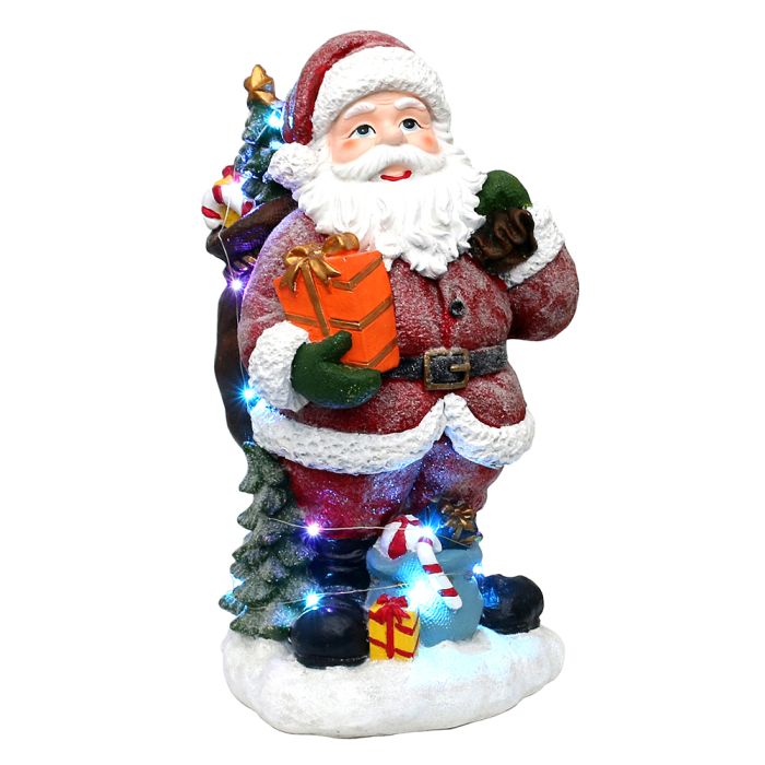 Snedrysset stor Julemand med gavesække og juletræ. Han lyser ægte op og smitter med sit godmodige og smilende ansigt, fra Sigro.