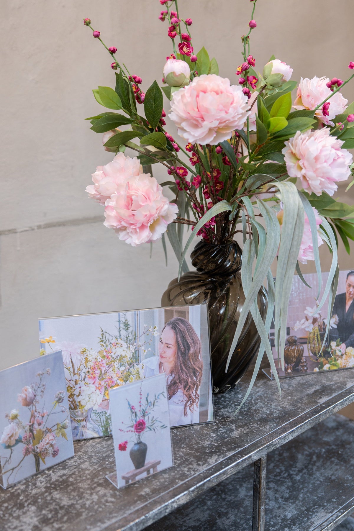 Speedtsberg picture frame on a dresser with a vase of pink flowers and small decorative pictures