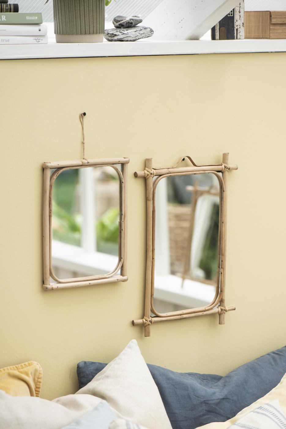 Mirrors with bamboo frame by Ib Laursen hanging above a bed