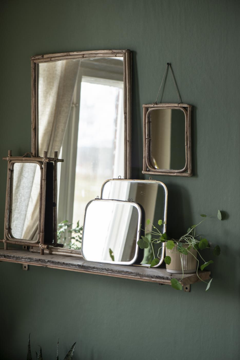 Assorted Ib Laursen mirrors on a wall shelf