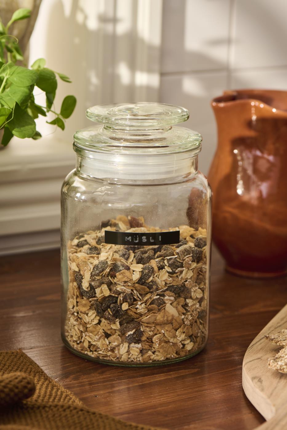 Storage jars from Ib Laursen filled with dry goods on a rustic kitchen table