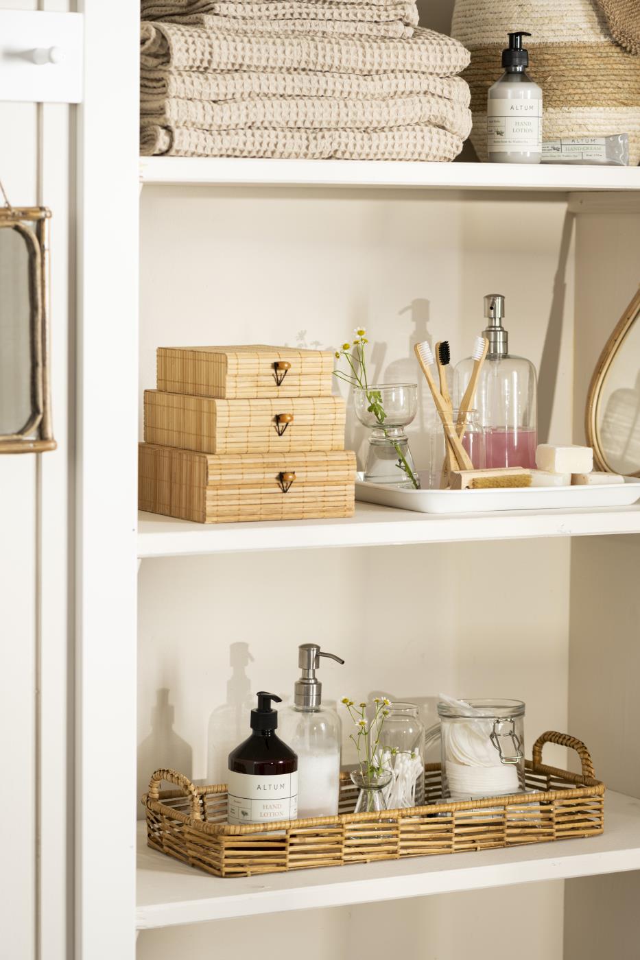 Bright bathroom with beige towels from the Liseleje series and wooden shelves with bathroom accessories