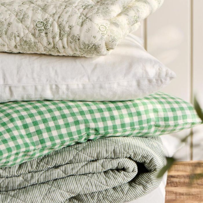 Quilt with white and dusty green milk boy stripes