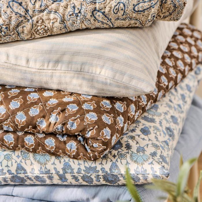 Brown quilt with blue floral pattern