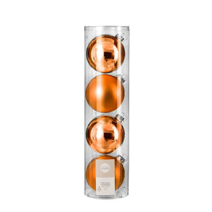 Julekugler i orange farve i glas.