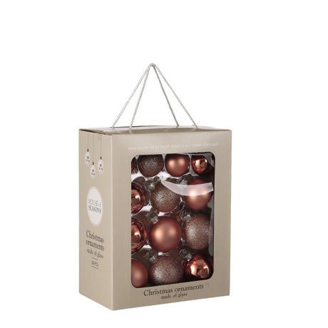 Julekugler i lyserøde nuancer i glas. 