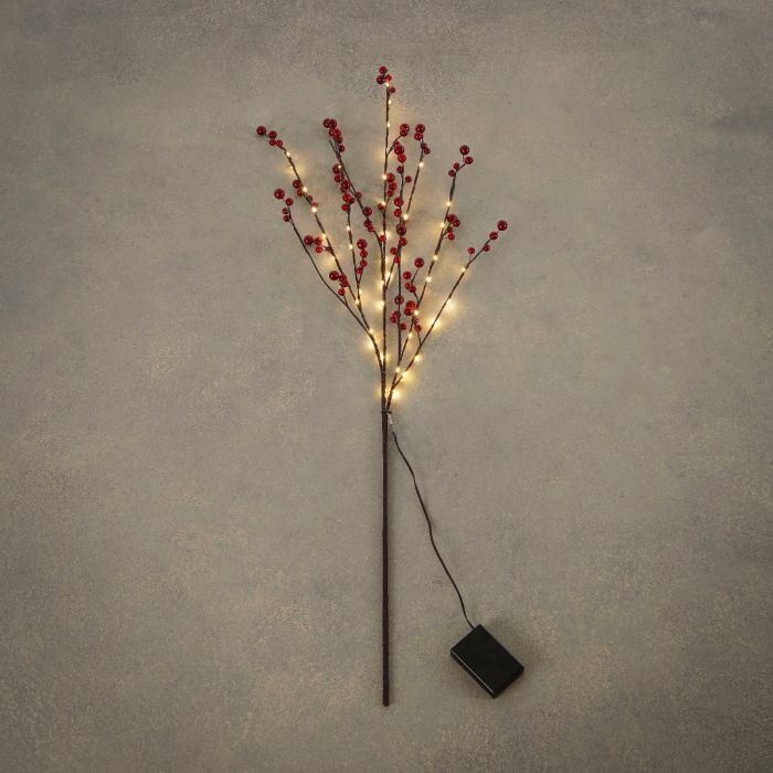 Gren med bær og lys indendørs brug