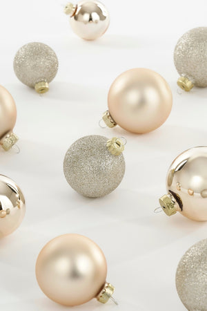 Glass Christmas baubles in cream shades with matte, glossy and glitter finishes