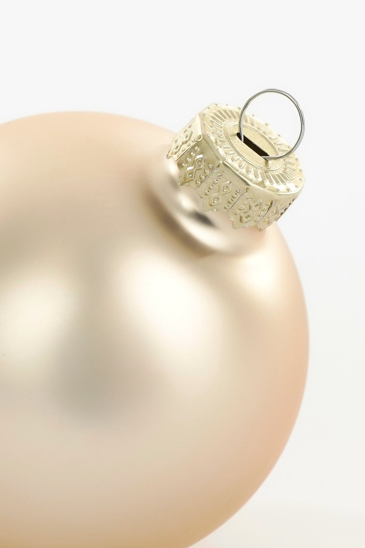 Top of matte cream-colored glass Christmas bauble