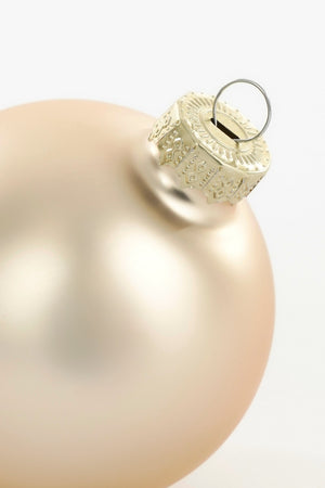Top of matte cream-colored glass Christmas bauble