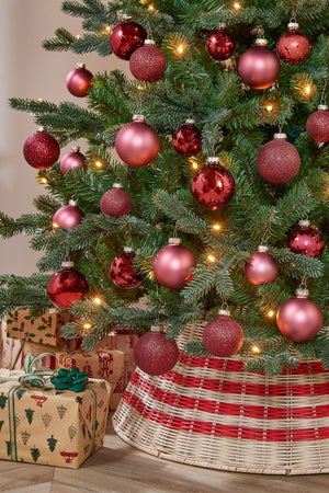 Christmas tree decorated with glass baubles in burgundy tones