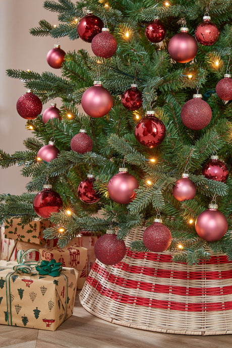 Christmas tree decorated with glass baubles in burgundy tones