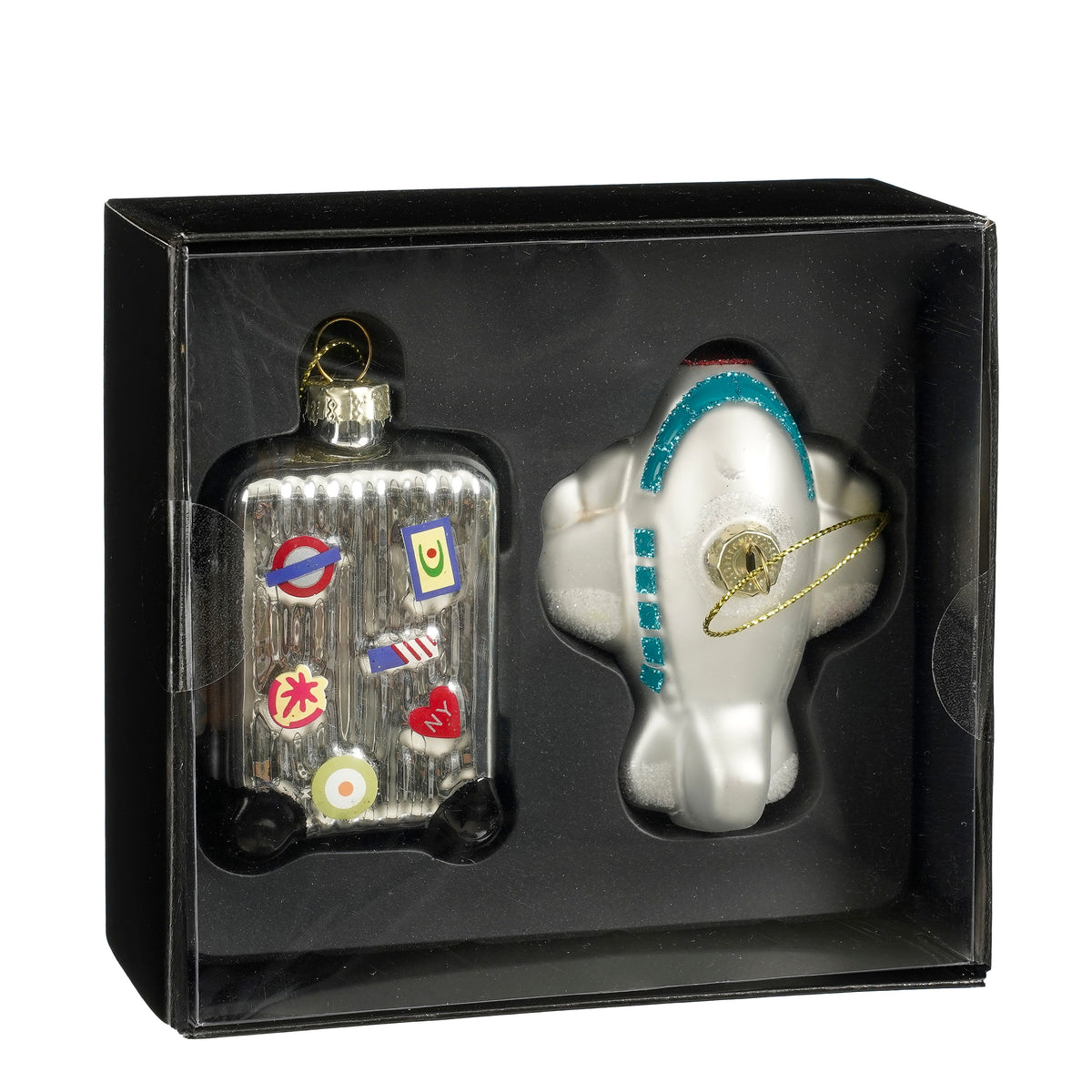 Set of glass figurine Christmas ornaments featuring a suitcase and an airplane