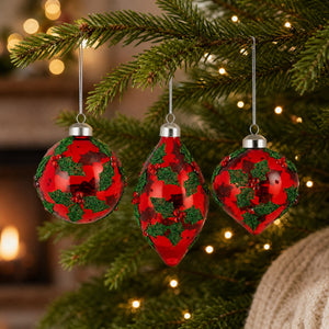 Red glass Christmas baubles with holly