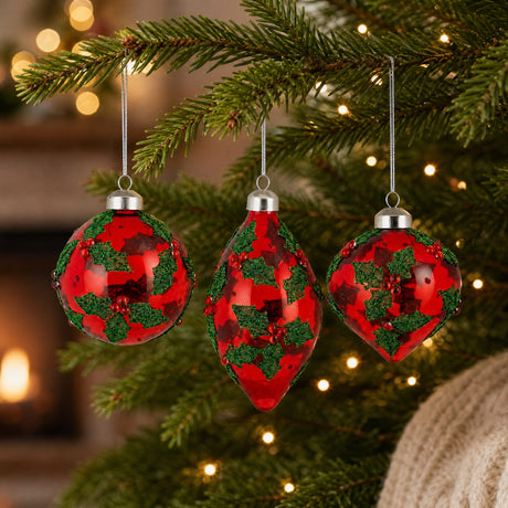 Red glass Christmas baubles with holly