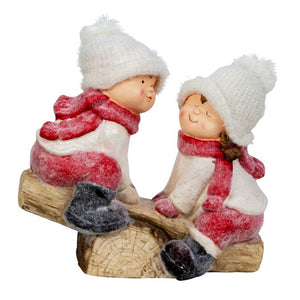 Winter children on a seesaw