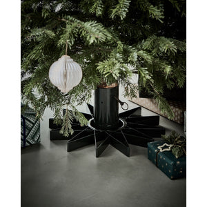 Christmas tree in a star-shaped stand from House Doctor with presents under the tree