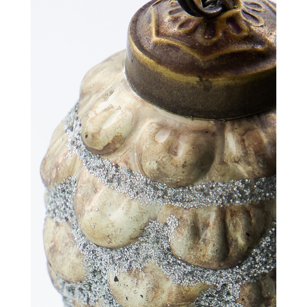 Close-up of the top and silver-glitter pattern on the cone-shaped Christmas ornament from House Doctor