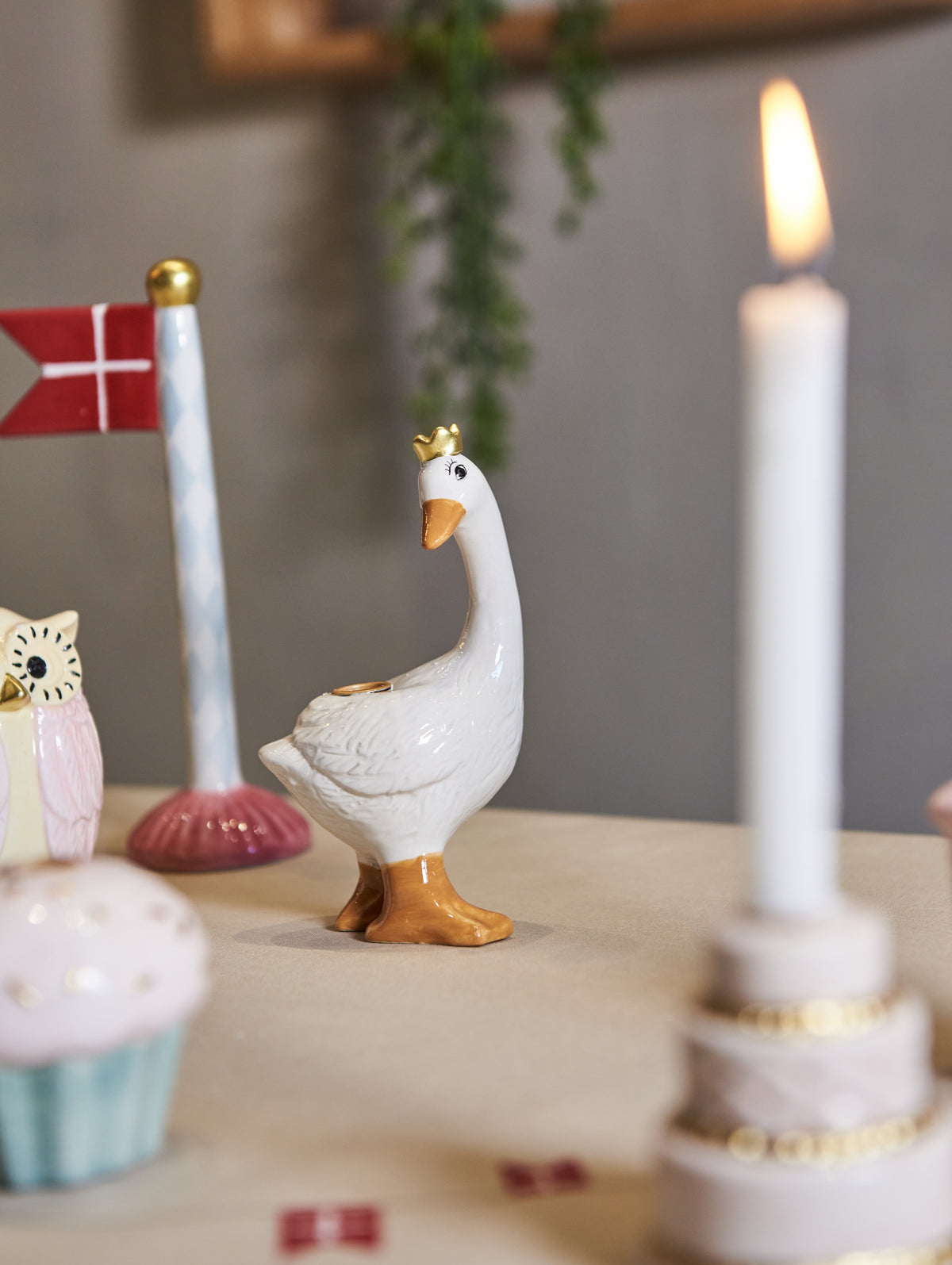 Goose-shaped taper candle holder on a birthday table