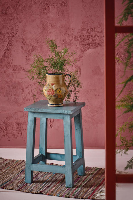 Blue-painted pine stool by Ib Laursen with a vase and plant