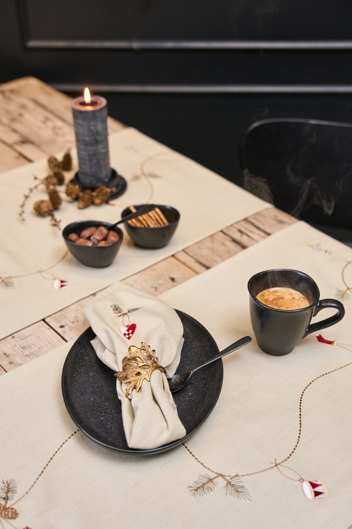 Two Christmas table runners on a wooden table