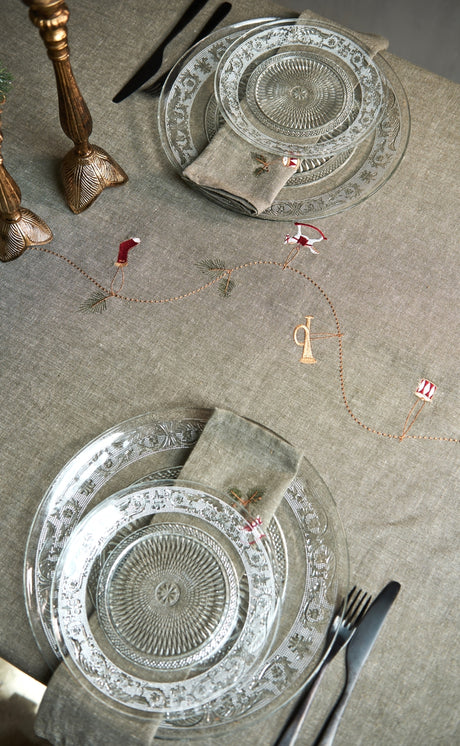 Christmas table set with gray-green textiles featuring embroidered Christmas motifs from Speedtsberg