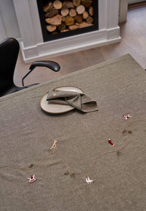 Table laid with a Speedtsberg Christmas tablecloth in gray-green heathered fabric