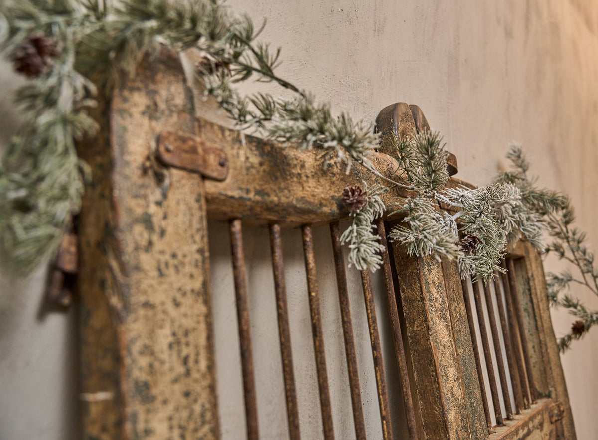 Old farm gate decorated with artificial frosted cedar garland from Speedtsberg