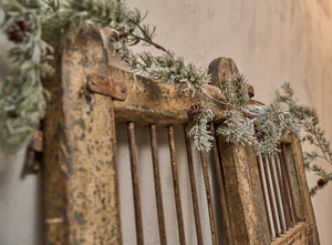 Old farm gate decorated with artificial frosted cedar garland from Speedtsberg