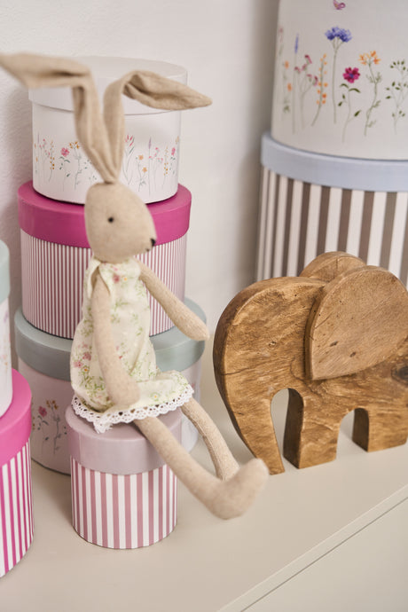 Blød Lulu kanin i stof 33 cm høj fra Speedtsberg sidder på en æske ved en elefant i træ