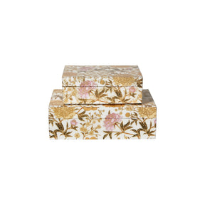 Set of two MDF storage boxes from Speedtsberg with a white base, yellow and pink flowers, and gold-colored details