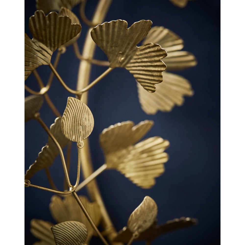 Close-up of the leaves on a gold-colored wreath from House Doctor