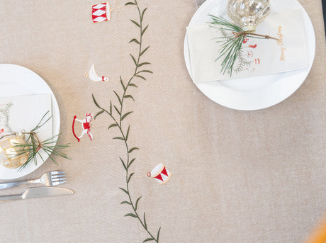 Christmas table set with baubles on silk fir branches