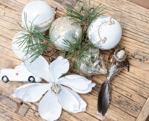Christmas ornaments, a glass sparrow and flower clips lying on a table