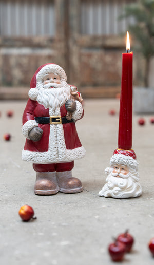 Santa beside a candle holder with a Santa-face design from Speedtsberg