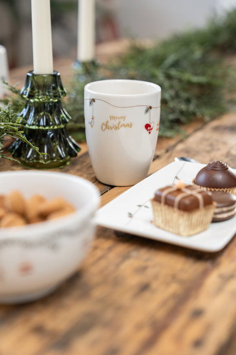 Porcelain Christmas dinnerware from Speedtsberg on a festively set holiday table