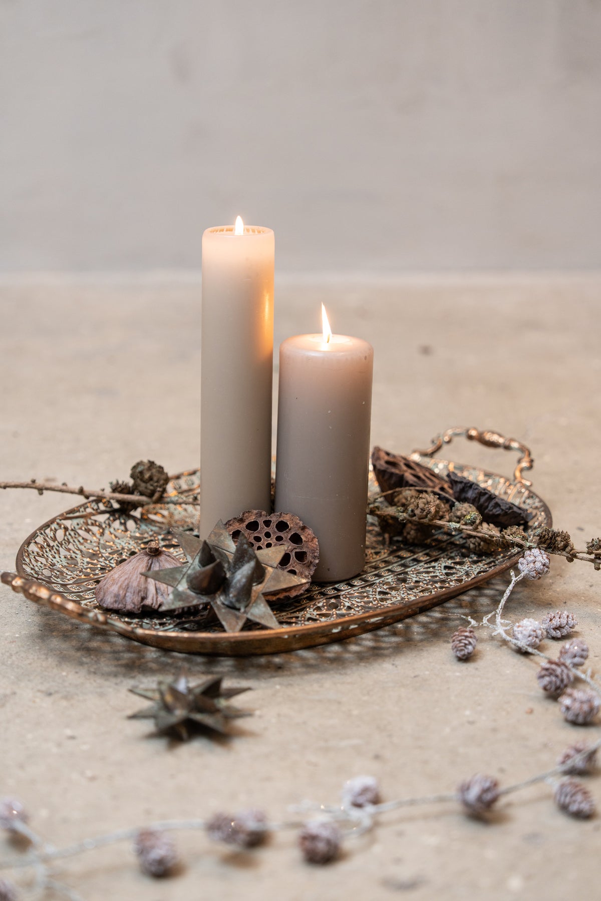 Candle tray with pillar candles, pinecone branches and woven stars in grey metal from Speedtsberg
