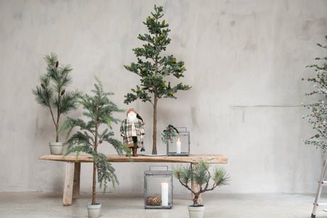 Artificial spruce trees from Speedtsberg by a stream with lanterns and a Santa figure
