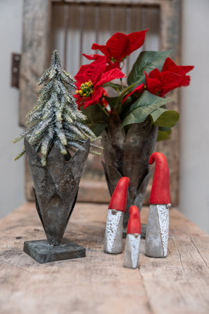 Rustic vases with artificial poinsettia bouquet and fir tree