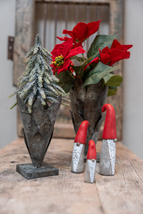 Rustic vases with artificial poinsettia bouquet and fir tree