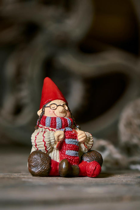 Ingeborg with knitting from Ribenisserne by Ib Laursen, sitting on a table
