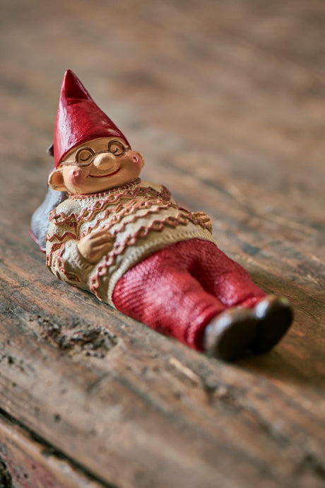 Thorvald, the Ribe elf from Ib Laursen, is sleeping on a dark wood table