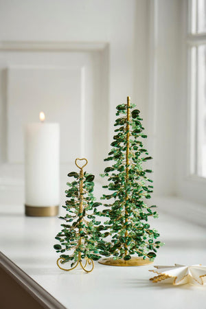 Christmas trees with green beads in two sizes from Ib Laursen on a windowsill